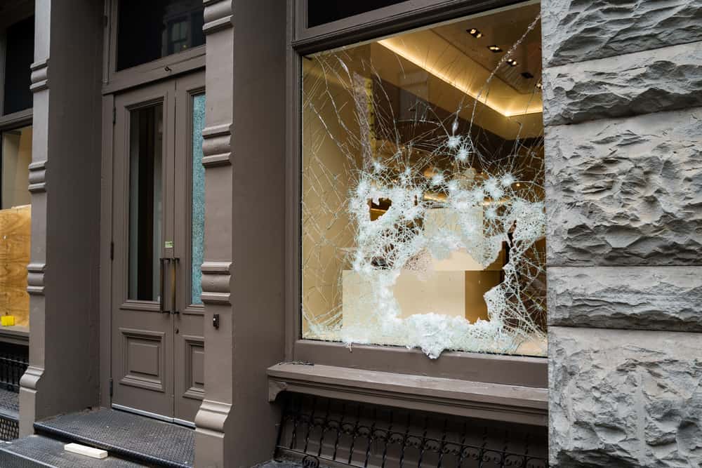 storefront with broken window from vandals.
